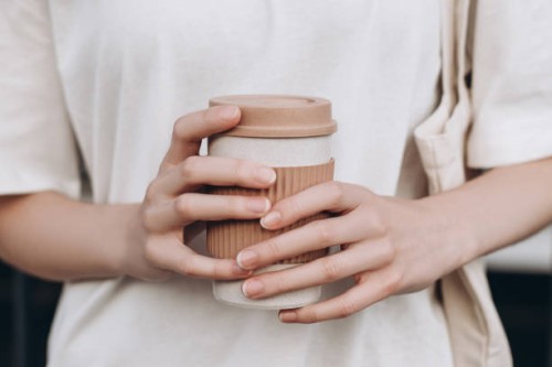female hands hold reusable coffee mug - junk food stock pictures, royalty-free photos & images