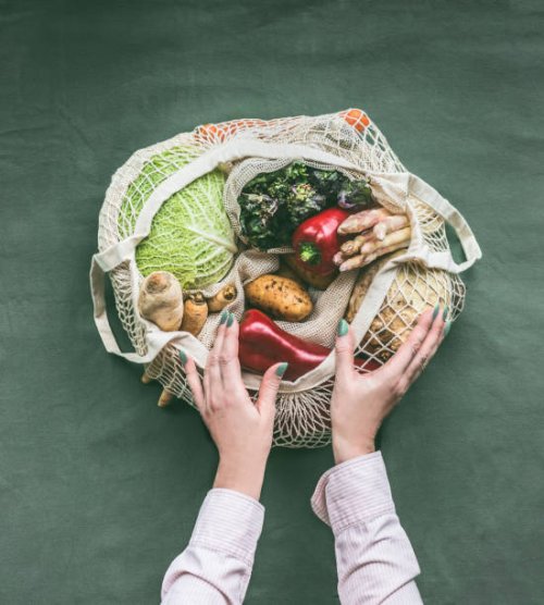 female hands holding eco friendly mesh shopping bag with vegetables - food stock pictures, royalty-free photos & images