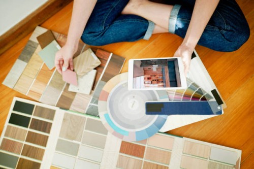 female interior designer using a tablet while looking over swatches at work - home decoration stock pictures, royalty-free photos & images