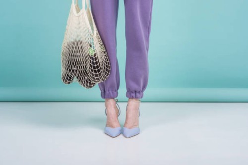 female legs and string bag with eggplant studio shot. - fashion stock pictures, royalty-free photos & images