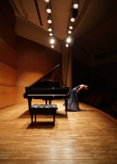 female pianist bowing on concert hall stage - concert stock pictures, royalty-free photos & images
