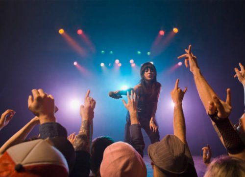 female rock star on stage interacting with audience - concert stock pictures, royalty-free photos & images