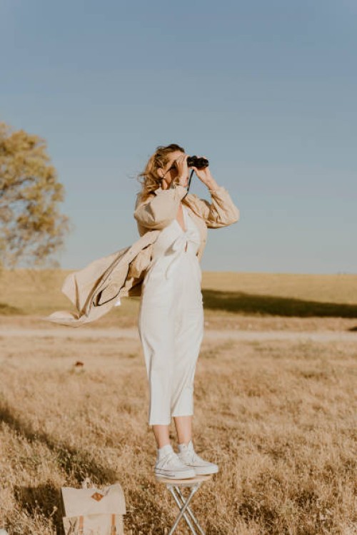 female traveller looking through binoculars - fashion stock pictures, royalty-free photos & images