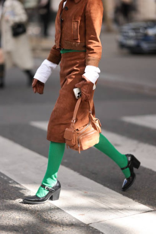 Fer Millán Delaroière is seen wearing a matching two-piece in brown suede from Miu Miu, consisting of a cropped jacket with ribbed trims, a black...