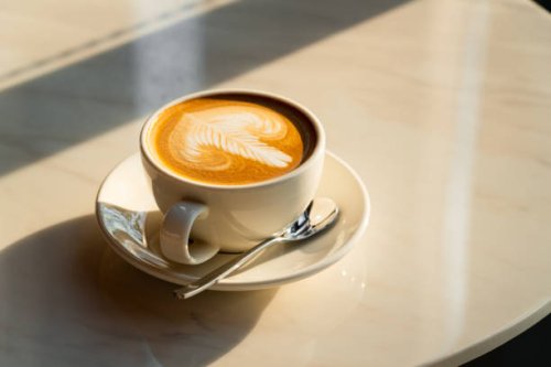 feshly brewed latte coffee on a white table - coffee stock pictures, royalty-free photos & images