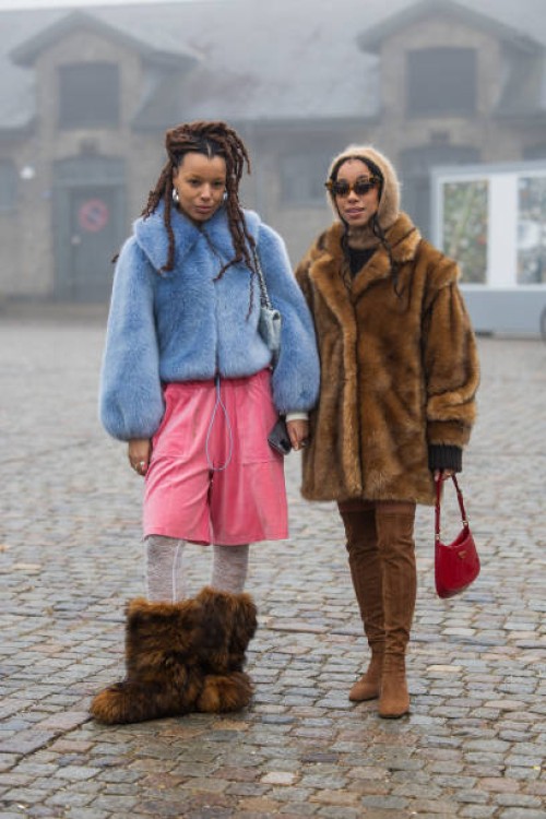 Fia Hamelijnck wears blue jacket, pink pants, fur boots & Amaka Hamelijnck wears brown fur coat, balaclava, red Prada bag, over knee wild leather...