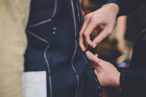 fingers pinning a tailored suit - fashion stock pictures, royalty-free photos & images