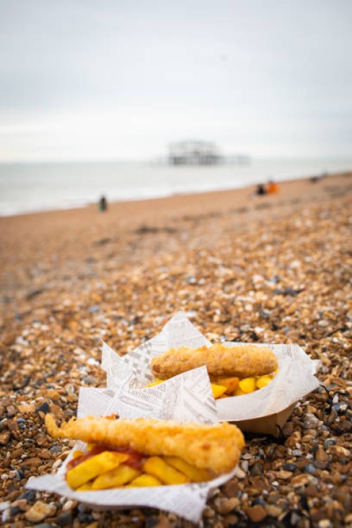 fish and chips on the beach - junk food stock pictures, royalty-free photos & images