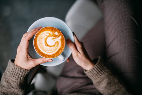 flat lay woman hand holding coffee latte - coffee stock pictures, royalty-free photos & images