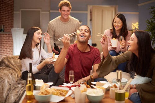 flatmates enjoying take away - junk food stock pictures, royalty-free photos & images