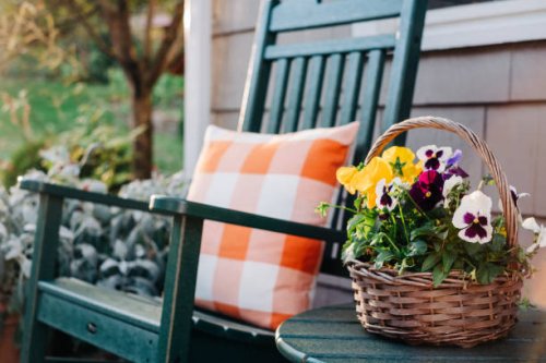 flower basket next to a green rocking chair - garden decoration stock pictures, royalty-free photos & images
