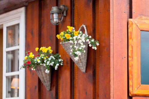 flowers in wicker pots on a icelandic wooden house - garden decoration stock pictures, royalty-free photos & images