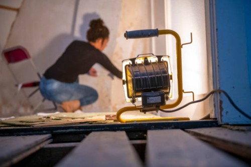 focused diy enthusiast paints a wall in a room undergoing renovation - home decoration stock pictures, royalty-free photos & images