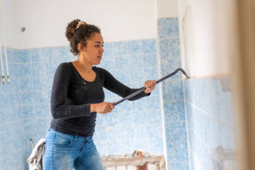 focused young woman renovating her home - home decoration stock pictures, royalty-free photos & images