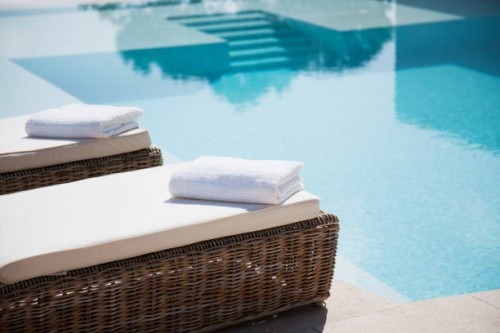 folded towels on lounge chairs beside pool - home decoration stock pictures, royalty-free photos & images
