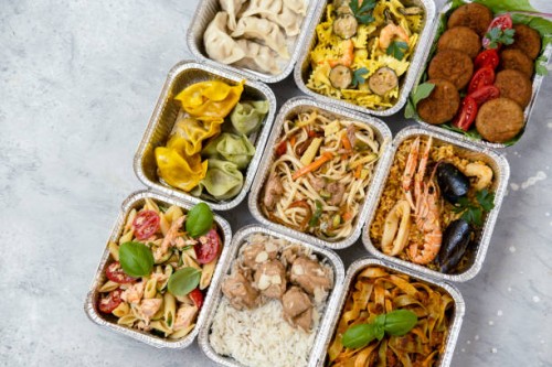 food delivery. сhinese takeaway food, italian food delivery. different aluminium lunch box with dumplings, noodles with chicken, rice with chicken, pasta with salmon, falafel - junk food stock pictures, royalty-free photos &