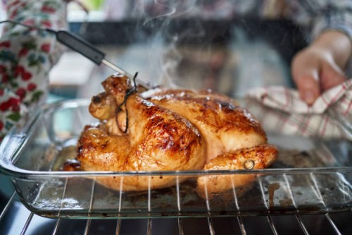food safety - roasting chicken in the oven with digital thermometer - food stock pictures, royalty-free photos & images