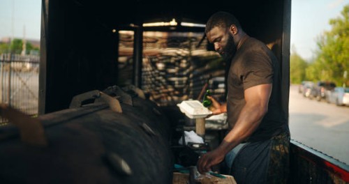 food truck owner holding takeout container and bottle - junk food stock pictures, royalty-free photos & images
