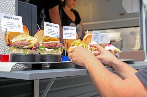 food truck owner serving burger - junk food stock pictures, royalty-free photos & images