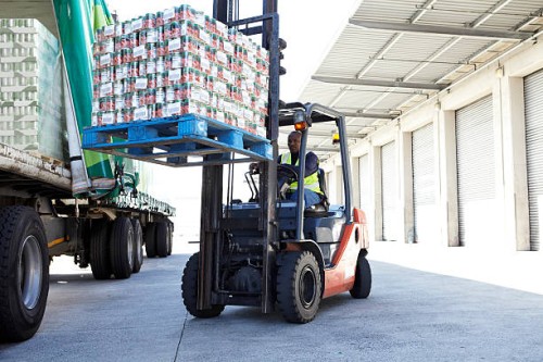 fork lift truck loading a lorry - food stockfoto's en -beelden