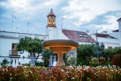 fountain with flowers in the town square of estepona, malaga, spain at sunset - garden decoration stock pictures, royalty-free photos & images