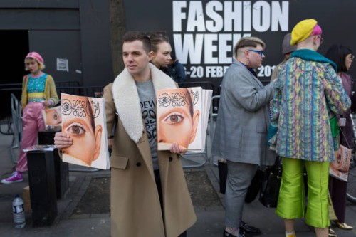 Free magazines featuring a model's eye on the cover are being handed out on the first day of London Fashion Week, in the Strand, on 16th february...