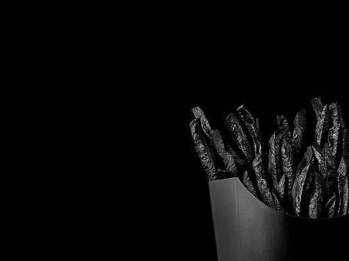 french fries on black backdrop - junk food stock pictures, royalty-free photos & images