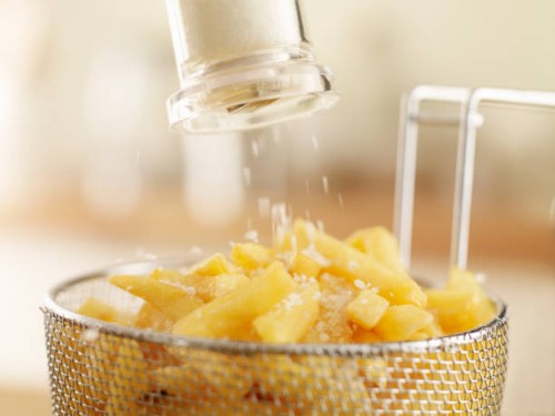 french fries sprinkled with salt - junk food stock pictures, royalty-free photos & images