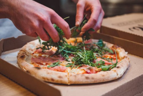 fresh arugula on a pizza - junk food stock pictures, royalty-free photos & images