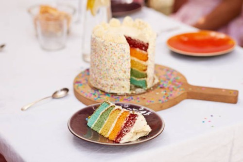 fresh birthday cake with slice on dining table - garden decoration stock pictures, royalty-free photos & images