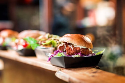 fresh crispy pork burgers in a row at food market - junk food stock pictures, royalty-free photos & images
