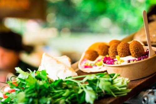 fresh falafel and salad on display at vegan vegetarian stall at food market - junk food stock pictures, royalty-free photos & images