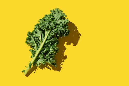 fresh green organic kale leaves on yellow background. healthy food, diet and detox concept. flat lay, top view, copy space - food stock pictures, royalty-free photos & images