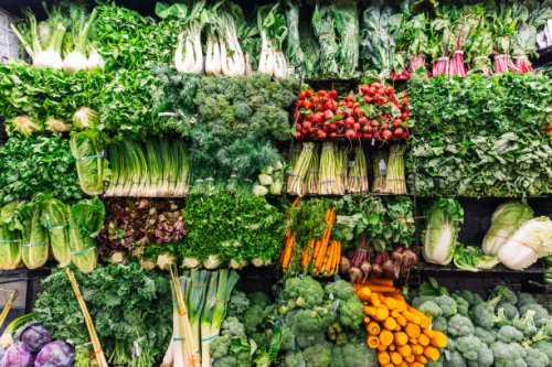 fresh greens and vegetables on a display in a supermarket - food stock pictures, royalty-free photos & images
