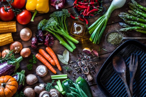 fresh vegetables ready for cooking shot on rustic wooden table - food stock pictures, royalty-free photos & images