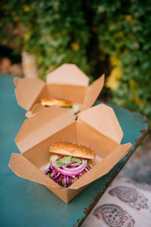freshly prepared burgers in take away boxes on table at restaurant - junk food stock pictures, royalty-free photos & images