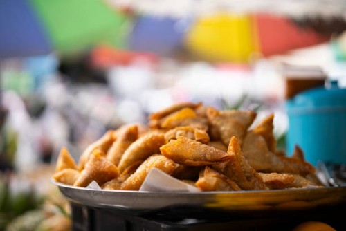 fried samaosas, a fried indian snack, selling at morning market in thailand - junk food stock pictures, royalty-free photos & images