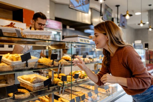 friendly transaction in bakery - junk food stock pictures, royalty-free photos & images