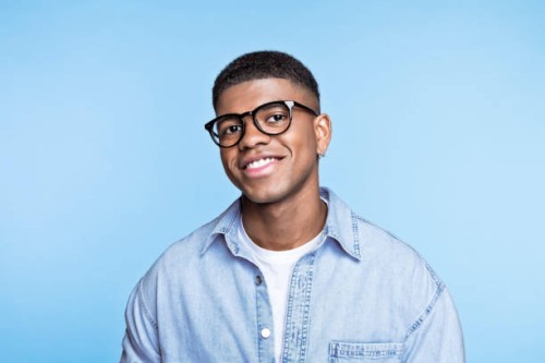friendly young man wearing denim shirt - fashion stock pictures, royalty-free photos & images