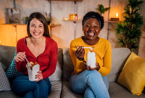 friends are eating and watching tv show - junk food stock pictures, royalty-free photos & images