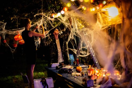 friends arranging halloween party decorations in the backyard - home decoration stock pictures, royalty-free photos & images