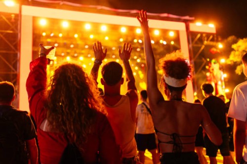 friends cheering band at concert - concert stock pictures, royalty-free photos & images