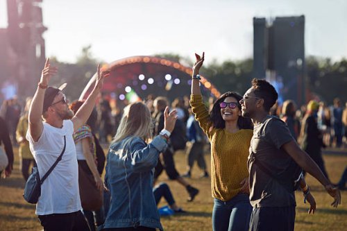 friends dancing at festival with arms in air - concert stock pictures, royalty-free photos & images
