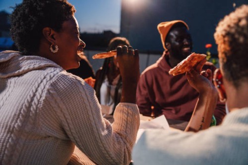 friends dining on a rooftop and having a toast - junk food stock pictures, royalty-free photos & images