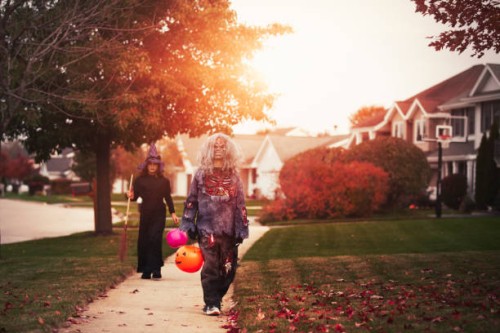 friends dressed as witch and zombie, trick or treating in neighbourhood - garden decoration stock pictures, royalty-free photos & images