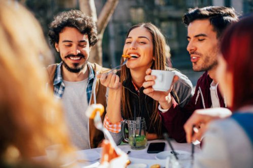 friends eating at a restaurant - food stock pictures, royalty-free photos & images