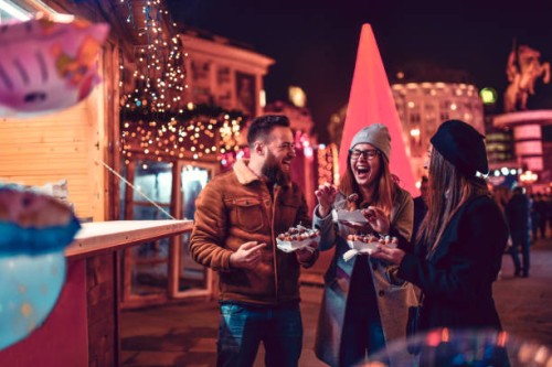 friends eating donuts and having fun at christmas fair - junk food stock pictures, royalty-free photos & images