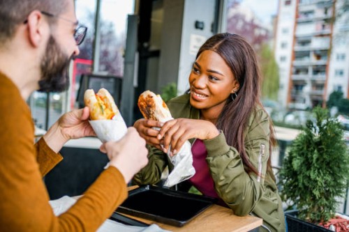 friends eating in a fast food restaurant - junk food stock pictures, royalty-free photos & images