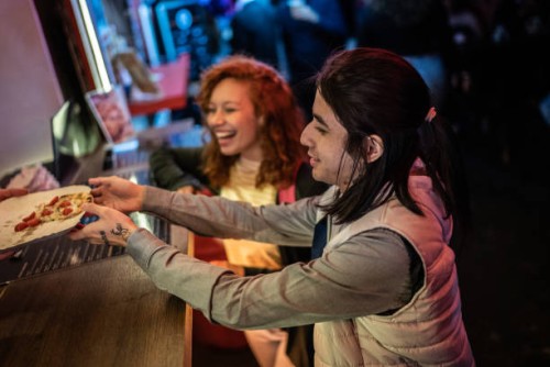 friends eating pizza outdoors at night - junk food stock pictures, royalty-free photos & images