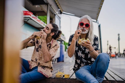friends eating street food together - junk food stock pictures, royalty-free photos & images